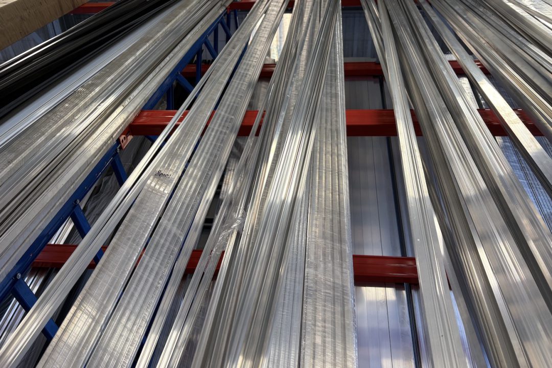 Rows of aluminium glazing bar extrusions in a warehouse