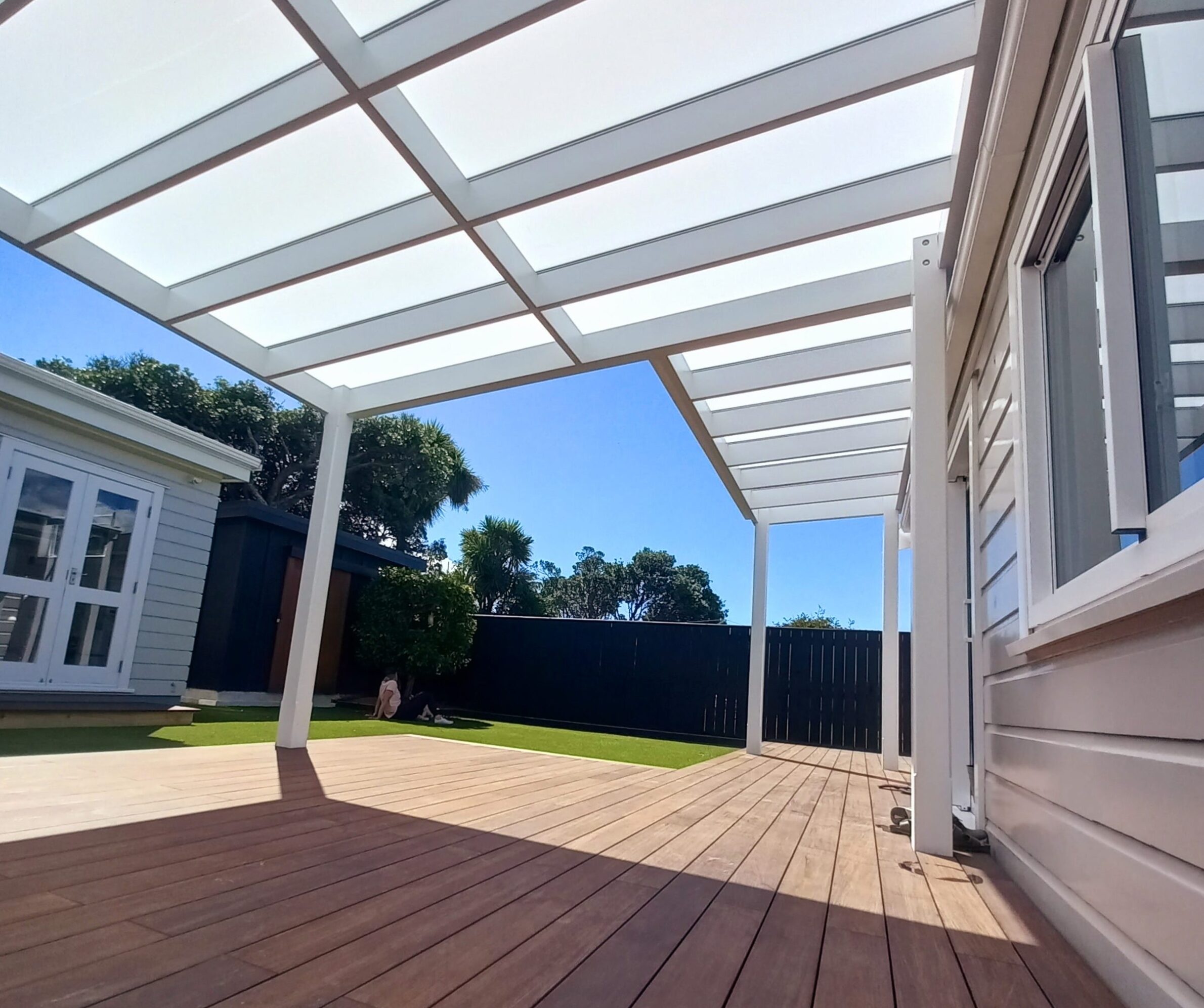 ClearSpan Box Enclosed outdoor living area with ClearSpan roof and blinds